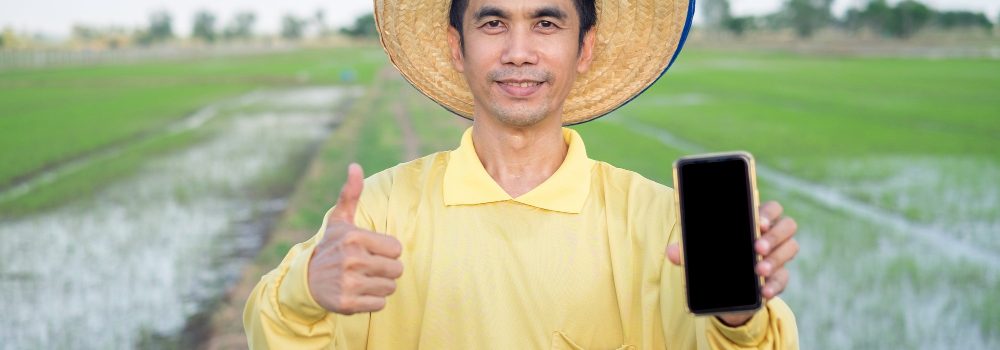 asian-farmers-wear-yellow-shirts-holding-smartphone-thumb-up-green-farm