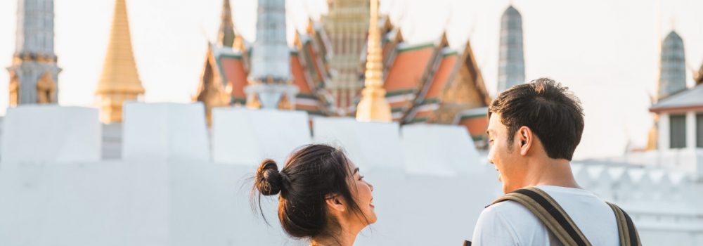 Traveler Asian couple traveling and walking in Bangkok, Thailand, sweet Asia couple feeling happy spending sweet time in holiday trip in sunset. Lifestyle couple travel in city concept.